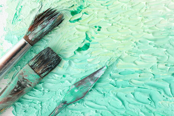 Abstract colorful artwork and brushes, closeup view