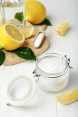 Baking soda and cut lemons on white wooden table