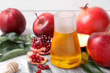 Fototapeta na wymiar Honey, apples and pomegranate on table. Rosh Hashanah holiday