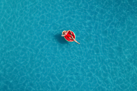 Young Happy Woman With Inflatable Ring In Swimming Pool, Top View. Summer Vacation