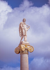Apollo, the ancient Greek god of arts under impressive sky, Athens Greece