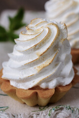 Basket shaped cupcake with whipped cream on top in a spiral tower shape