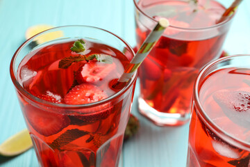 Refreshing drink with strawberry on table, closeup