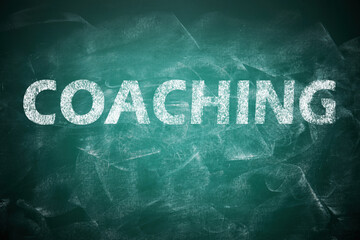 Business or life training. Word Coaching on green chalkboard