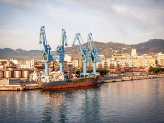 Fototapeta na wymiar cargo ship moored at the quay of the port of Palermo on a sunny spring morning