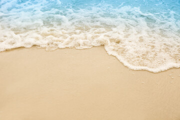 Fototapeta na wymiar Sea waves rolling on beautiful sandy beach, closeup. Summer vacation