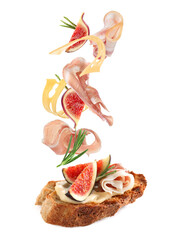 Tasty bruschetta with flying ingredients on white background