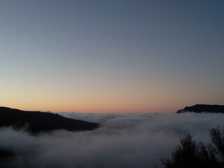 Sunset top mountain peak over cloud flying, liberty trailing