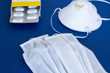 Medical face masks N95 on blue surface with medicine box