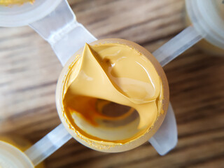 A jar of yellow paint close up, open jar with yellow paint