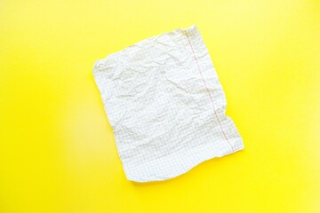A white sheet of paper in a cage on a bright yellow background.