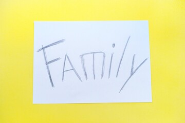 The text of the family on a white sheet of paper in a cage on a bright yellow background. Destruction and divorce. Step by step.