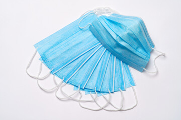 coronavirus COVID-19 pandemic concept - stack of antiviral surgical protective medical mask for...