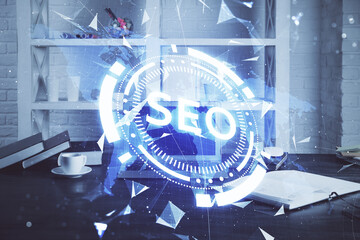 Multi exposure of table with computer and seo drawing hologram. Search optimization concept.