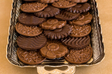Madlen chocolate designed  in vintage silver tray on kraft paper background,close up taken