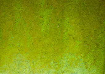 Old green uneven grainy background with spots. Artificial synthetic material. Closeup