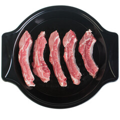 Pork ribs in a baking dish, on a white background, isolate