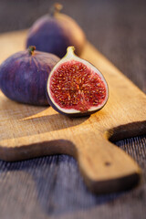 cut open figs on a wooden cutting board