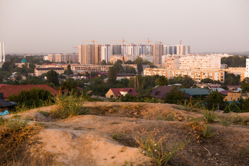Fototapeta premium private houses on the background of high-rise buildings