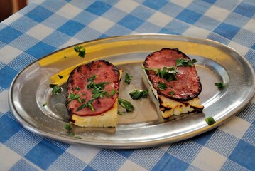 Grilled halloumi cheese and ham served with parsley in Cyprus