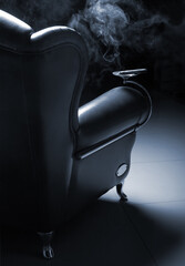 Cigar and beautiful leather armchair on marble to floor