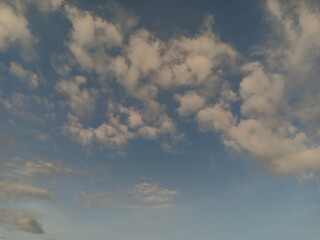 white clouds against a blue sky background