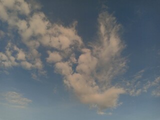 Naklejka na ściany i meble white clouds against a blue sky background