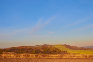 Obraz premium autumn landscape at sunset,late autumn with fog at sunset on a background of mountains