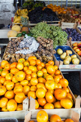 Colorful fruits and vegetables on a street market. Mandarins, figs,pears on a counter.