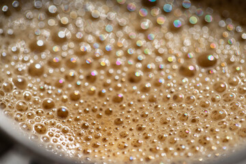 coffee in a cup with foam and bubbles.