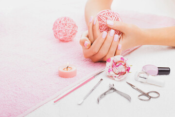 beautiful pink manicure with rose,manicure set, on the white and pink towels