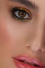 Obraz premium Half a beauty portrait with beautiful fashionable evening make-up, black jiggles on eyes and extremely long eyelashes. Natural lipstick on the lips and blue eyehadow. Cosmetology and facial skin care