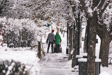 Fototapeta na wymiar Couple snow clearing on the sidewalk 