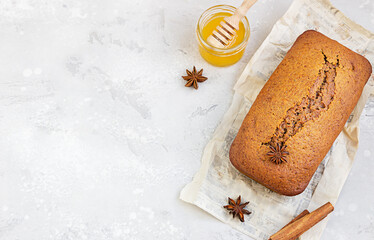 Spicy honey cake with cinnamon and anise star on light grey concrete background. Honey cake for Rosh Hashanah.