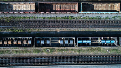 Aerial view of rail sorting freight station with railway cars, with many rail tracks railroad. Heavy industry landscape.