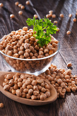 Composition with bowl of chickpeas on wooden table