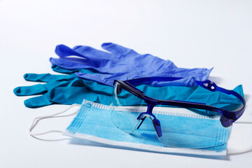  medical protective equuipment, nitrile gloves, blue, mask for the face, goggles, on a white background, horizontal, 