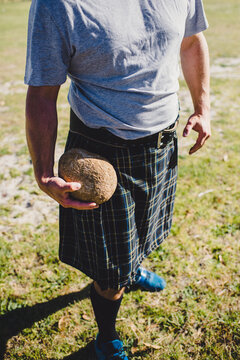 Kilt and traditional throwing stone for highland games