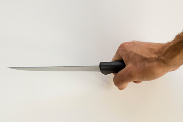 Hand of adult male holding a sharp knife on white background,close up.
