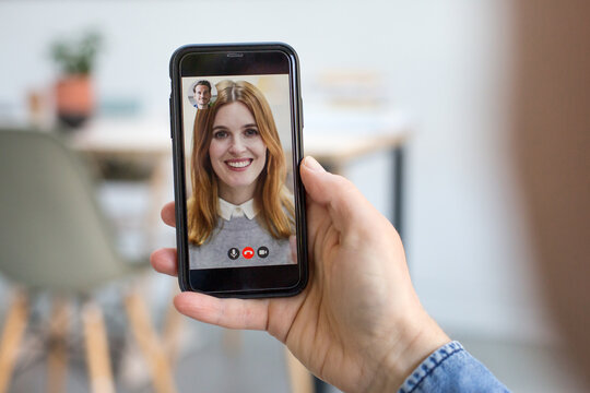 Person Using Video Conferencing technology for business meeting