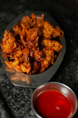 Crispy kanda pakora or kanda bhaji. Mumbai's road side snack. Favourite monsoon snack in India.