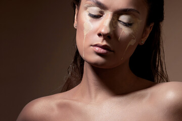 Concept portrait of a young beautiful girl with face art in the form of a map of the world.