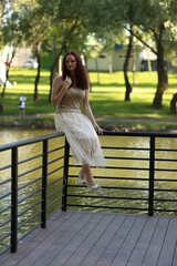 Naklejka premium Young curly haired woman near the lake