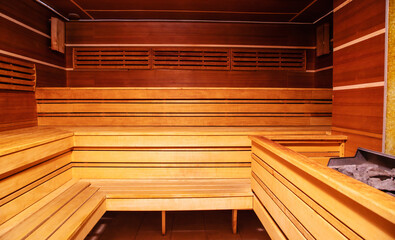 Interior of Finnish sauna or classic wooden sauna. Relax and treatment in the spa