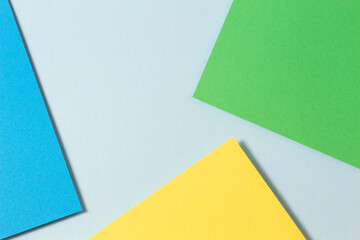 Abstract color papers geometry flat lay composition background with blue, yellow and green color tones