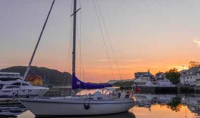 Fototapeta na wymiar Undiscovered Norway - Sailboat in the sunset