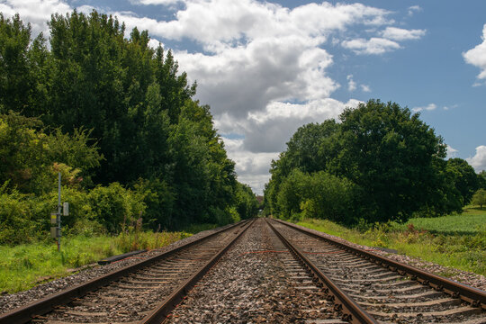 Perspective view up a twin track railway in the English countryside