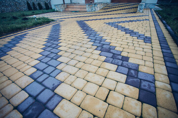 Stone pavement in perspective. Stone pavement texture. Granite cobblestoned pavement background. Abstract background of a cobblestone pavement