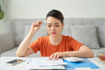 Housewife counting the calculator at home