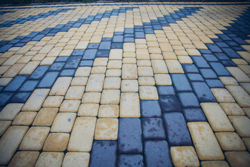 Stone pavement in perspective. Stone pavement texture. Granite cobblestoned pavement background. Abstract background of a cobblestone pavement